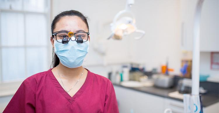 Lady with mask in a dental practice