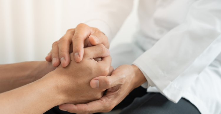 Doctor and patient holding hands