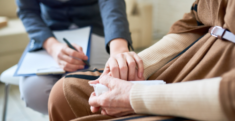 Therapist comforting someone and placing a hand on them