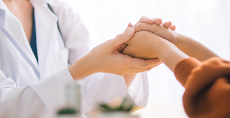 Doctor holding a patient's hands
