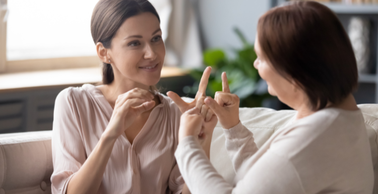 Two people communicating using sign language