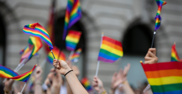 People waving pride flags
