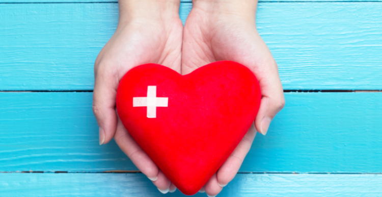 One pair of hands holding a 3D heart shape.