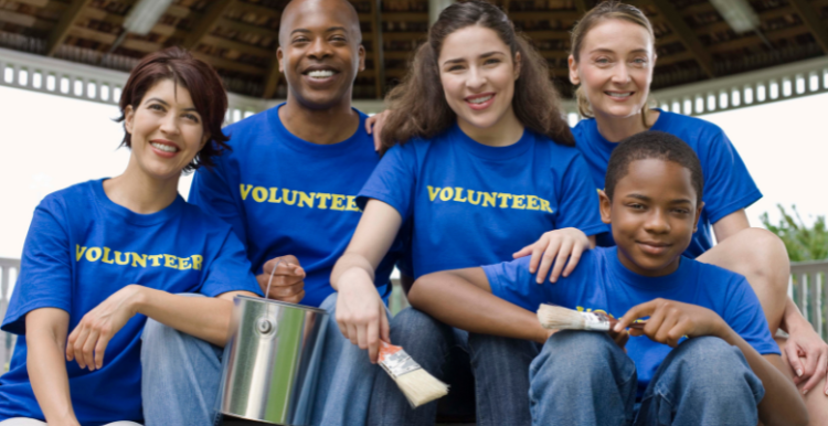 A picture showing a group of volunteers smiling.