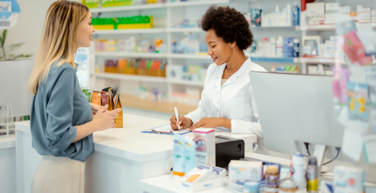 A pharmacist offering advice to a patient about their medication.