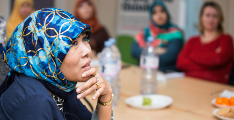 A group of women sitting around a table during a discussion.