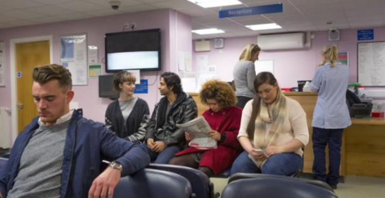 A group of patients sitting in the waiting area in a hospital or GP.