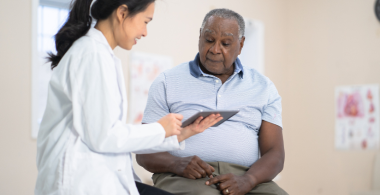 Female doctor talking to a male patient.
