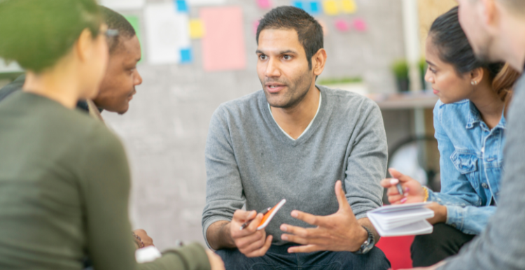 A man discussing his ideas with a group of people.