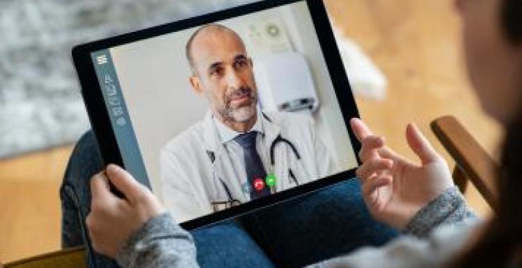 A woman having a video consultation using her tablet