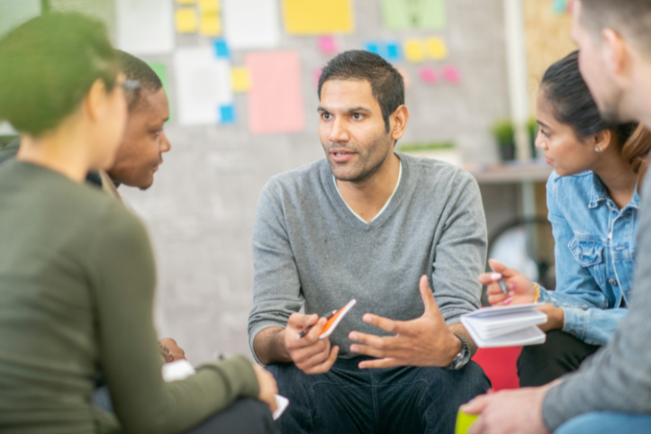 A man discussing his ideas with a group of people.