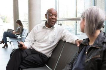 A man and a woman talking to each other while sitting