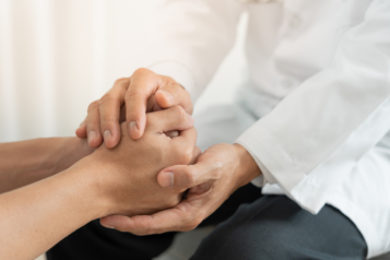 Doctor and patient holding hands