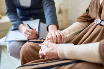 Therapist comforting someone and placing a hand on them