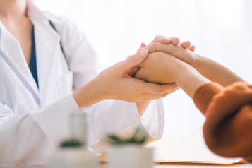 Doctor holding a patient's hands