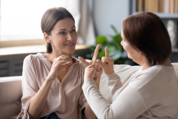 Two people communicating using sign language