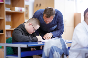A teacher supporting a student with a learning disability