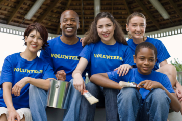 A picture showing a group of volunteers smiling.