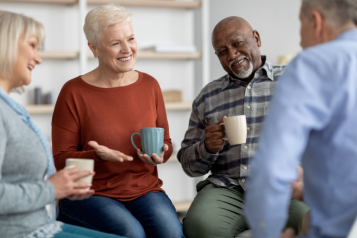 An image of a focus group taking place between some men and women who are talking to eachother.