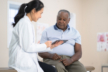 Female doctor talking to a male patient.