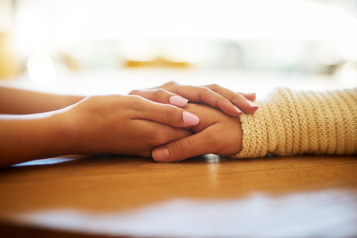 Two hands held in support of eachother.