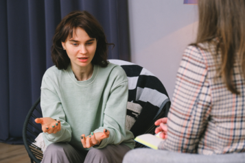 A woman talking to a psychiatrist.