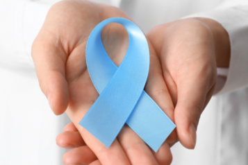 Two hands holding a blue ribbon to represent cancer 