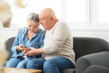 A senior couple checking their diabetes at home