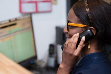 A female pharmacist talking on the phone 