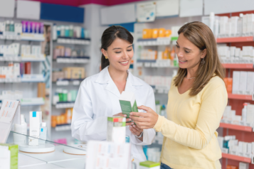 Female pharmacist assisting a female patient at the pharmacy