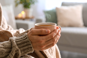 Hands holding a cup of hot drink