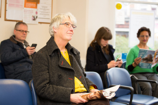Female patient waiting for her appointment at the GP clinic.