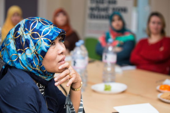 A group of women sitting around a table during a discussion.
