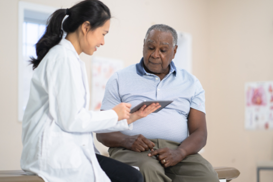 Female doctor talking to a male patient.