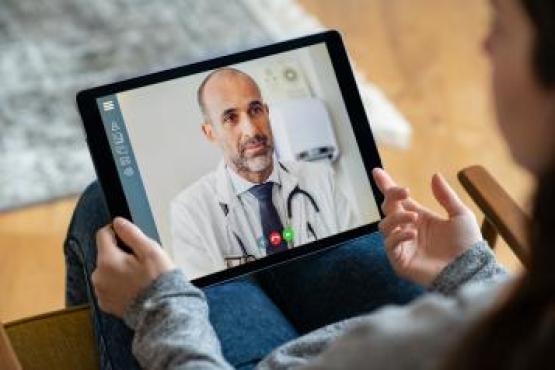 A woman having a video consultation using her tablet